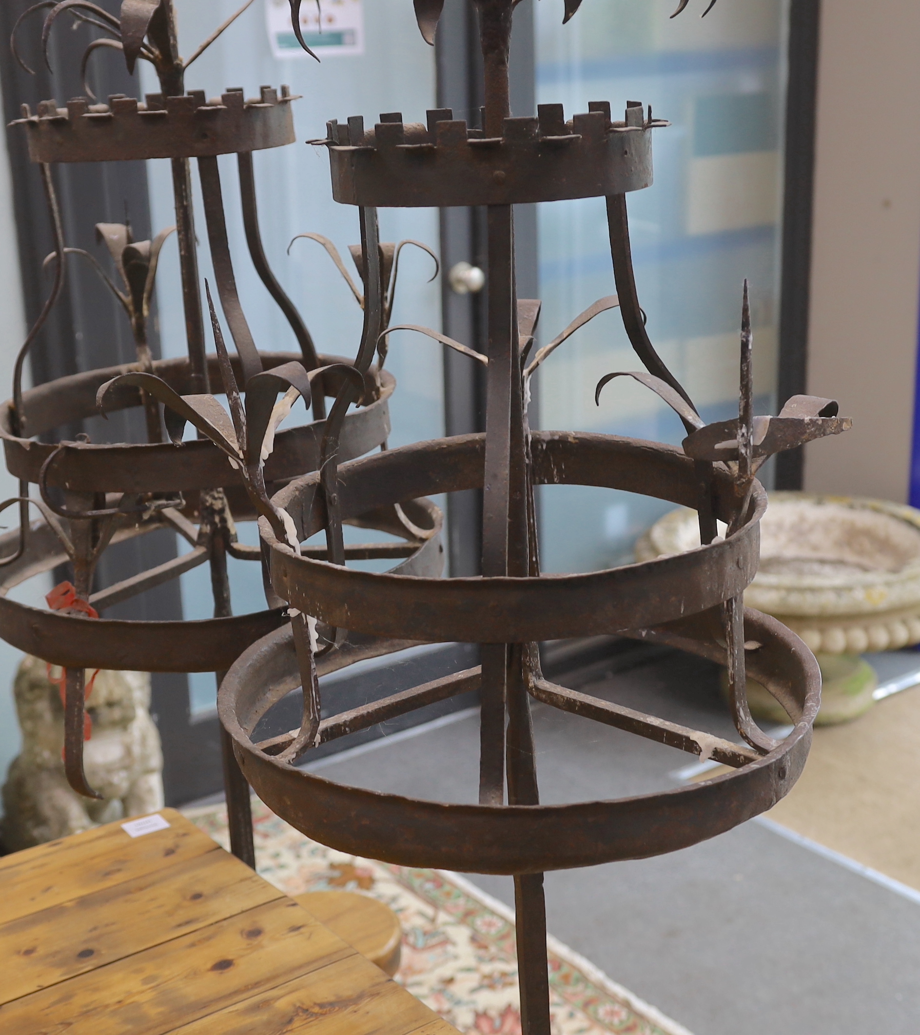 A pair of wrought iron floor standing candlestands, in 17th century style, height 171cm, Provenance- Brede Place, East Sussex, a former residence of the Frewen family from 1712-1936.